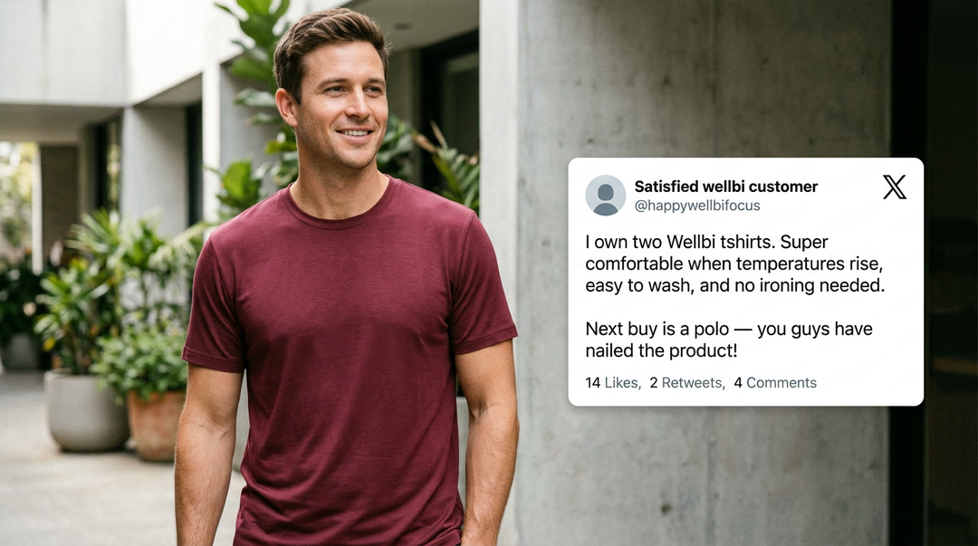 Man wearing a Wellbi burgundy bamboo t-shirt outdoors alongside a customer review praising its comfort in the heat, easy wash care and no-iron convenience — a repeat buyer already planning their next Wellbi purchase